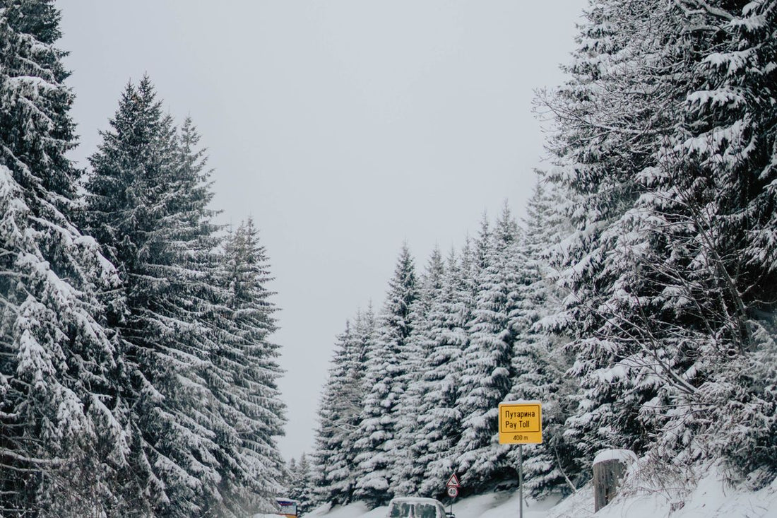 Car driving on a snowy winter road in Canada
