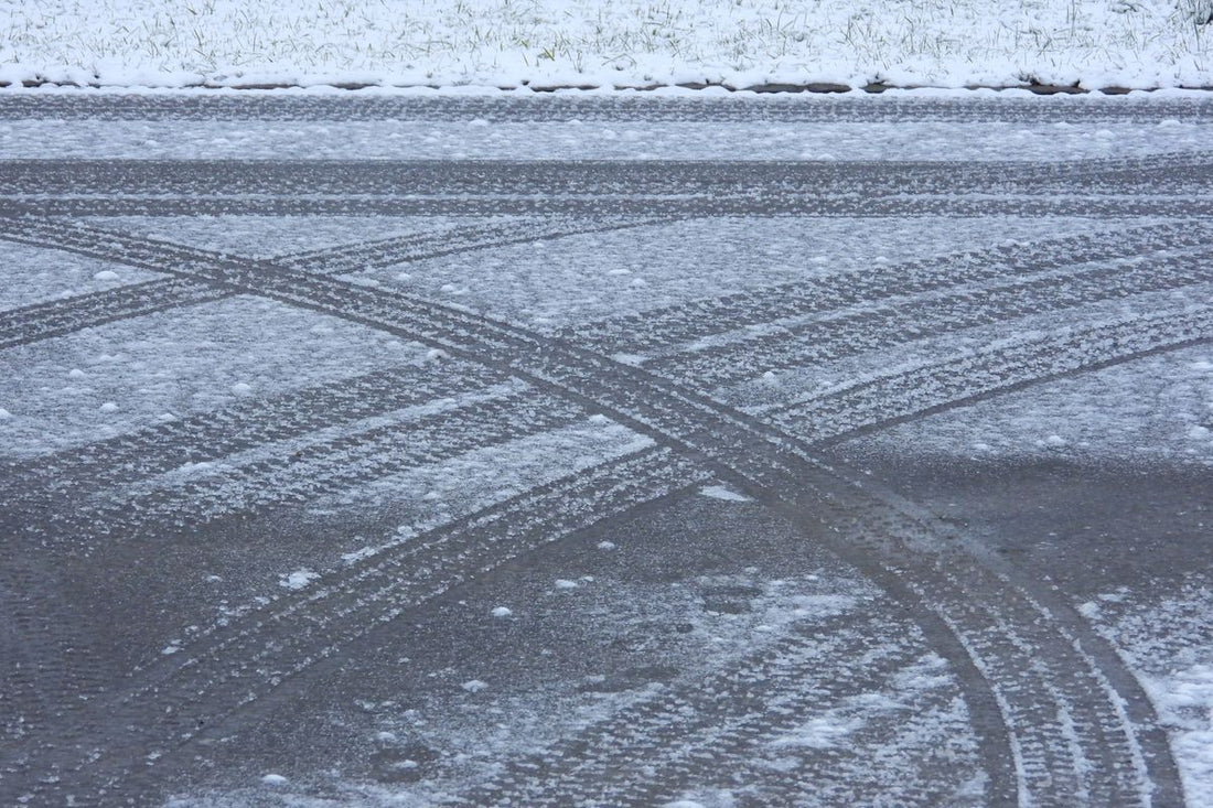 Snow-covered road with tire tracks illustrating Quebec's mandatory winter tire law