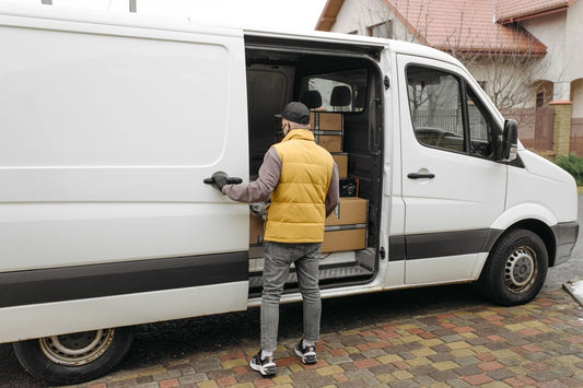 Delivery driver at a van, representing home tire delivery service in Montreal